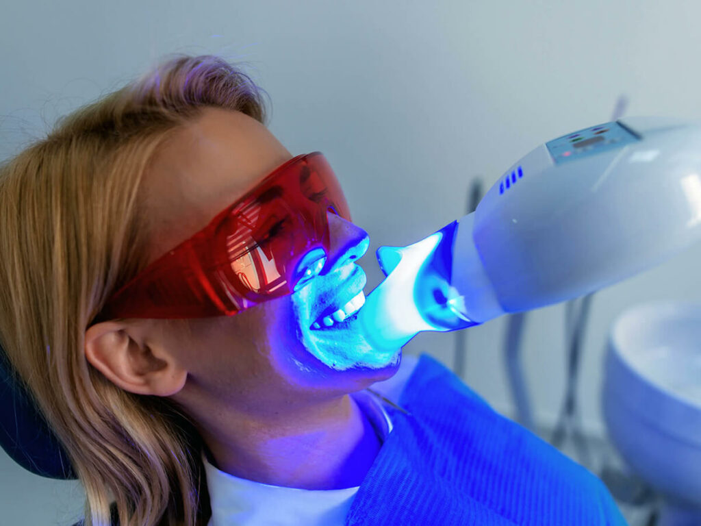 woman receiving teeth whitening service