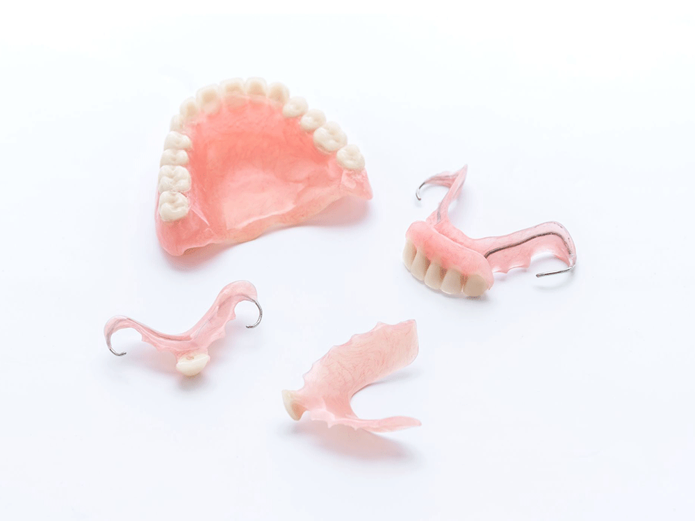 different types of dentures, full and partials, placed next to each other