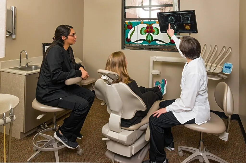 Dr. Jennifer Kunkel of Needville Family Dentistry showing a patient digital xrays
